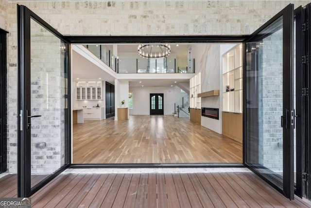 1255 E M Croy Rd, Sugar Hill, GA 30518 - interior space with hardwood / wood-style flooring, a chandelier, a fireplace, and a towering ceiling
