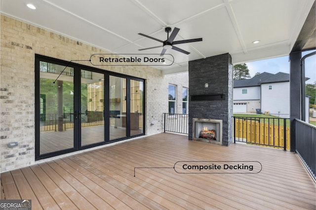 1255 E M Croy Rd, Sugar Hill, GA 30518 - deck featuring a fireplace and a ceiling fan