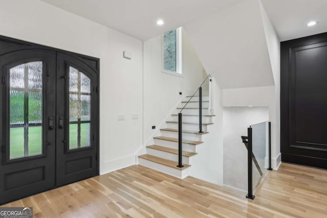 1255 E M Croy Rd, Sugar Hill, GA 30518 - foyer featuring french doors, wood finished floors, stairway, and recessed lighting