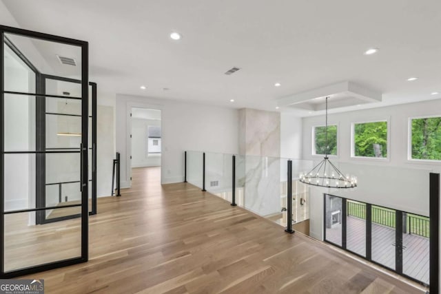 1255 E M Croy Rd, Sugar Hill, GA 30518 - hall featuring a chandelier, wood finished floors, recessed lighting, and a raised ceiling