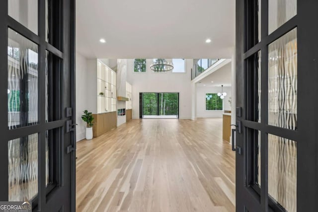 1255 E M Croy Rd, Sugar Hill, GA 30518 - entryway with a chandelier, light wood-style flooring, recessed lighting, and a high ceiling