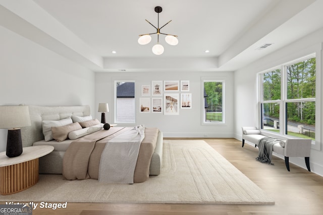 1255 E M Croy Rd, Sugar Hill, GA 30518 - bedroom featuring a raised ceiling, wood finished floors, a chandelier, and recessed lighting