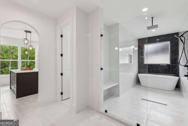 1255 E M Croy Rd, Sugar Hill, GA 30518 - bathroom with a walk in shower, a soaking tub, vanity, recessed lighting, and tile patterned flooring