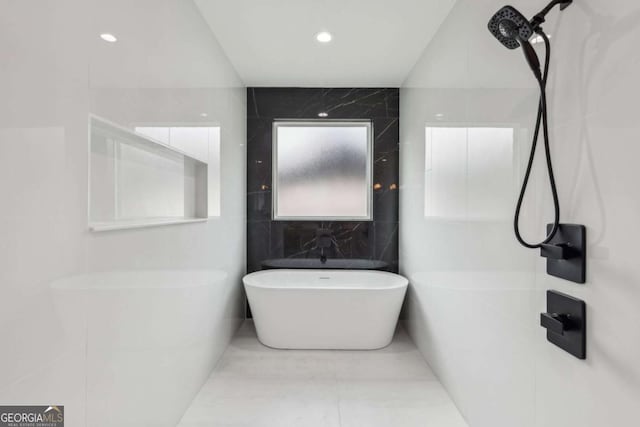 1255 E M Croy Rd, Sugar Hill, GA 30518 - full bath featuring a soaking tub, tile walls, and recessed lighting