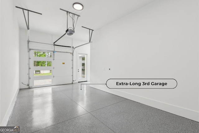 1255 E M Croy Rd, Sugar Hill, GA 30518 - garage with baseboards and a garage door opener