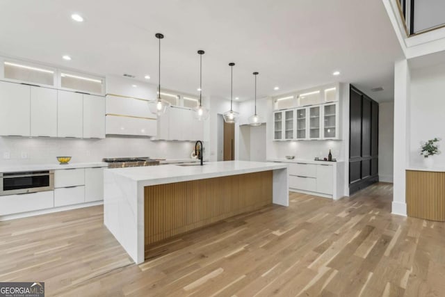 1255 E M Croy Rd, Sugar Hill, GA 30518 - kitchen featuring modern cabinets, white cabinets, light wood finished floors, and recessed lighting