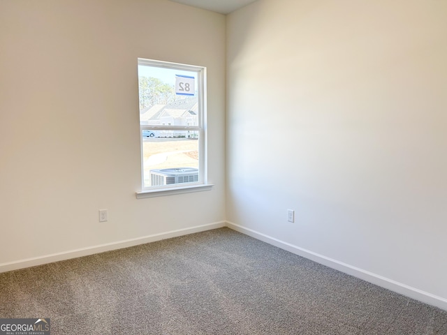 carpeted empty room with baseboards