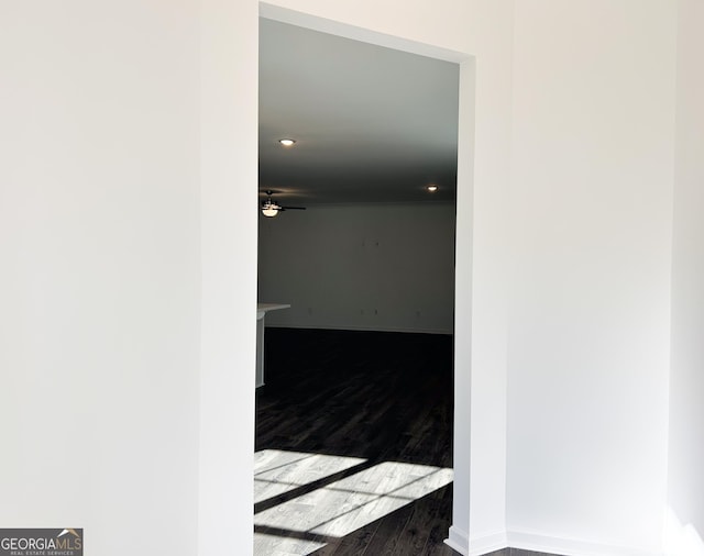 interior space with baseboards, recessed lighting, and dark wood finished floors