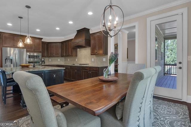 dining space featuring crown molding, recessed lighting, dark wood finished floors, and an inviting chandelier