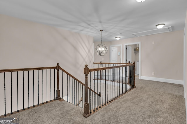 stairs featuring baseboards, carpet, and attic access