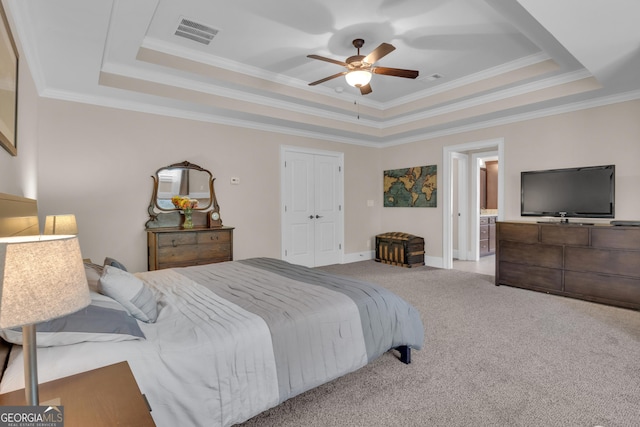 carpeted bedroom with crown molding, a ceiling fan, a tray ceiling, and visible vents