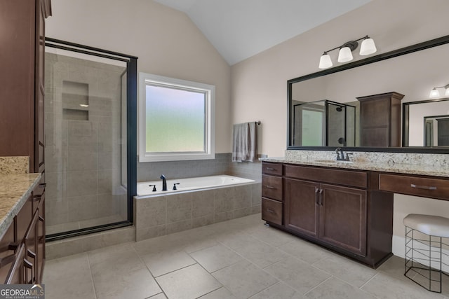 bathroom featuring vanity, tile patterned flooring, a shower stall, and lofted ceiling
