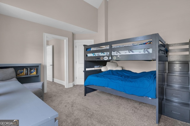 carpeted bedroom featuring baseboards