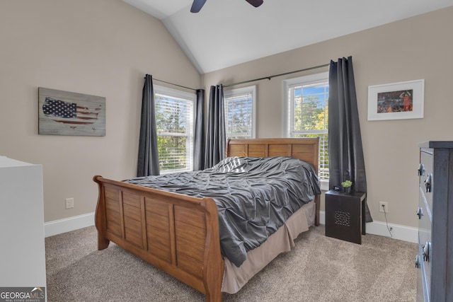 bedroom with baseboards, light carpet, ceiling fan, and lofted ceiling