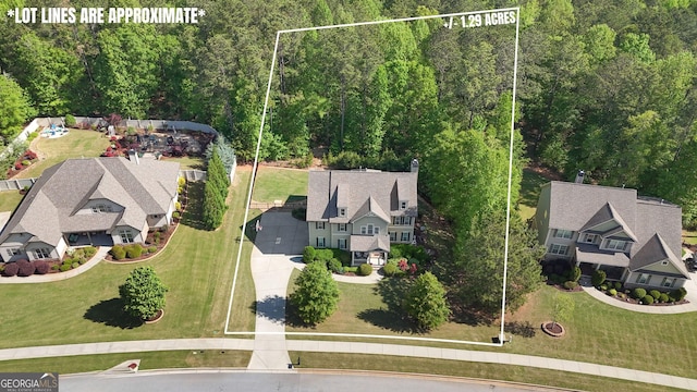 drone / aerial view featuring a forest view