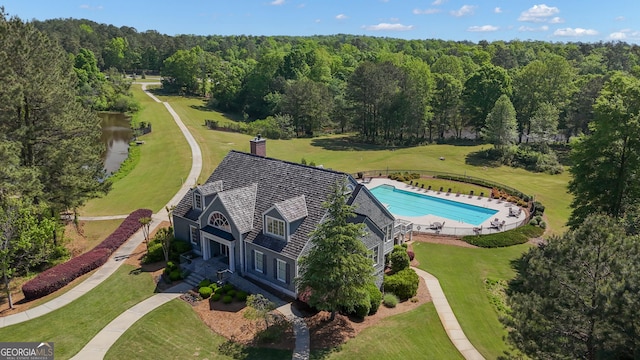birds eye view of property with a forest view