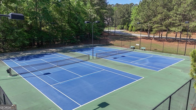 view of sport court with fence
