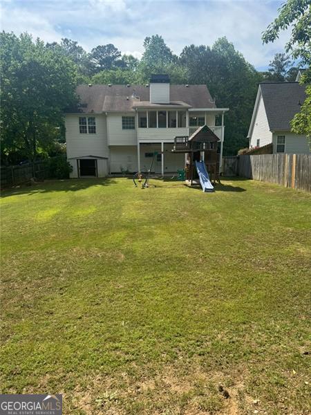 955 Tributary Way, Dacula, GA 30019 - back of house with a playground