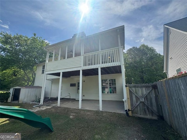955 Tributary Way, Dacula, GA 30019 - rear view of house with a patio area, a gate, a shed, and a playground