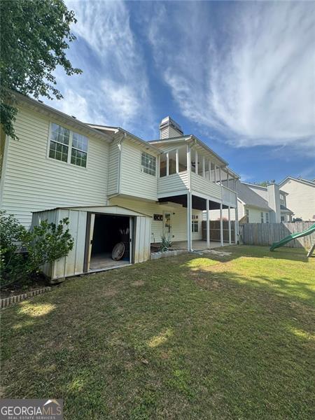 955 Tributary Way, Dacula, GA 30019 - back of property featuring a sunroom and a chimney