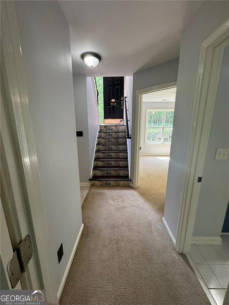 955 Tributary Way, Dacula, GA 30019 - hall featuring stairs, carpet floors, and baseboards