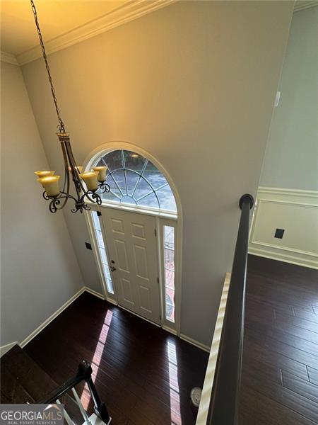 955 Tributary Way, Dacula, GA 30019 - foyer entrance with dark wood-type flooring, ornamental molding, and baseboards