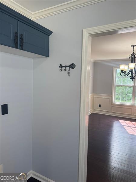 955 Tributary Way, Dacula, GA 30019 - mudroom featuring a chandelier, ornamental molding, dark wood finished floors, and a wainscoted wall
