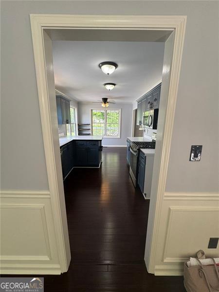 955 Tributary Way, Dacula, GA 30019 - corridor with dark wood-type flooring and a wainscoted wall