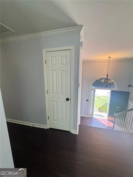 955 Tributary Way, Dacula, GA 30019 - empty room with ornamental molding, baseboards, dark wood-style floors, and a chandelier