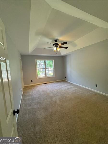 955 Tributary Way, Dacula, GA 30019 - unfurnished room featuring a raised ceiling, light carpet, baseboards, and a ceiling fan
