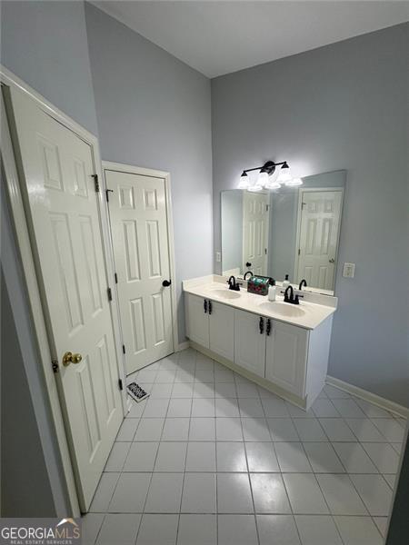 955 Tributary Way, Dacula, GA 30019 - full bathroom featuring double vanity and tile patterned flooring