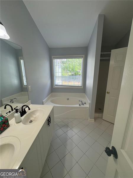 955 Tributary Way, Dacula, GA 30019 - bathroom with a garden tub, tile patterned flooring, double vanity, and a shower stall