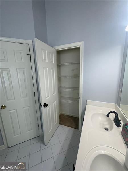 955 Tributary Way, Dacula, GA 30019 - bathroom with tile patterned floors and double vanity