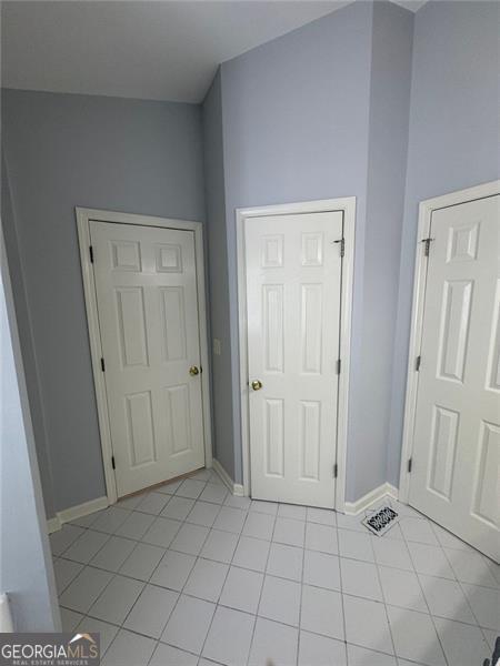 955 Tributary Way, Dacula, GA 30019 - unfurnished bedroom with light tile patterned flooring and baseboards