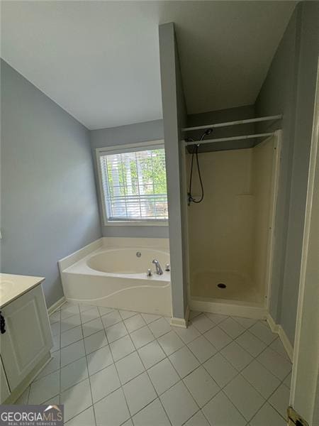 955 Tributary Way, Dacula, GA 30019 - full bath with vanity, tile patterned floors, a bath, a stall shower, and baseboards