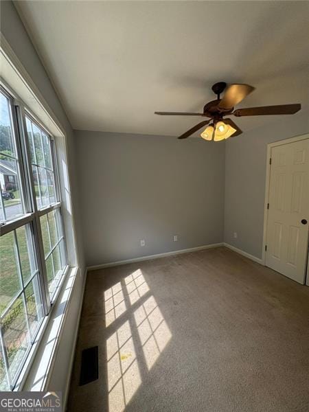 955 Tributary Way, Dacula, GA 30019 - spare room with plenty of natural light, carpet flooring, ceiling fan, and baseboards