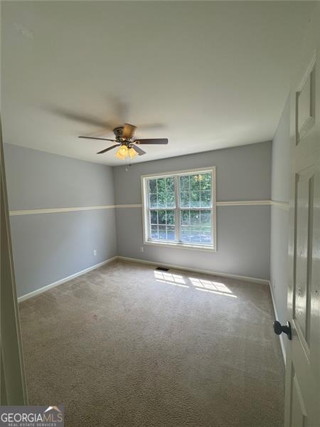 955 Tributary Way, Dacula, GA 30019 - carpeted spare room with ceiling fan and baseboards