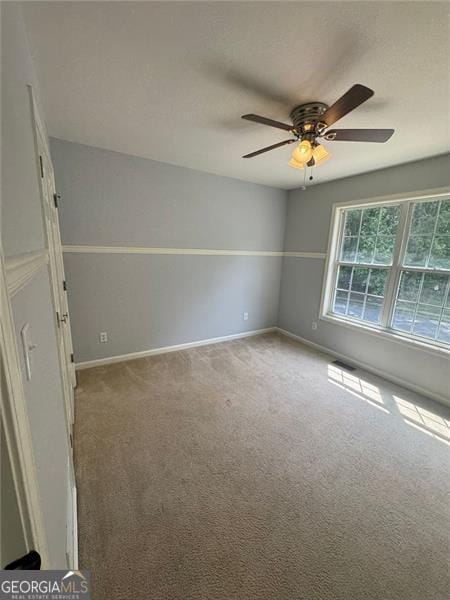 955 Tributary Way, Dacula, GA 30019 - unfurnished room featuring carpet floors, a ceiling fan, and baseboards