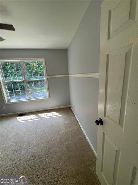 955 Tributary Way, Dacula, GA 30019 - empty room with carpet flooring, baseboards, and ceiling fan