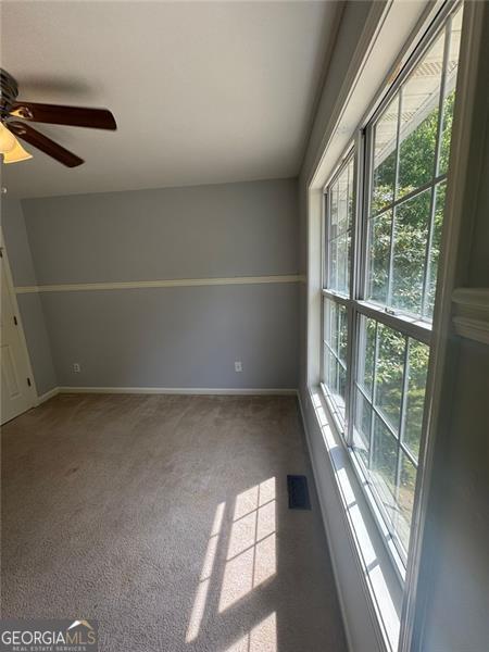 955 Tributary Way, Dacula, GA 30019 - spare room with plenty of natural light, a ceiling fan, carpet flooring, and baseboards