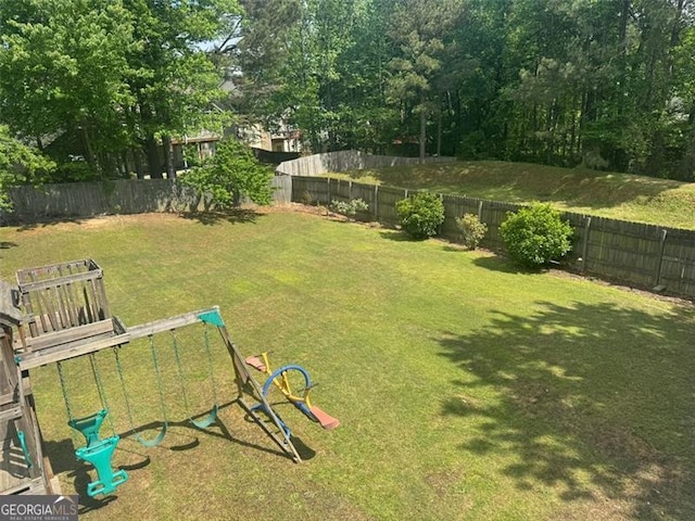 955 Tributary Way, Dacula, GA 30019 - fenced backyard featuring a playground
