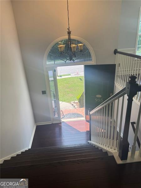 955 Tributary Way, Dacula, GA 30019 - entryway with a chandelier, hardwood / wood-style flooring, a towering ceiling, and baseboards