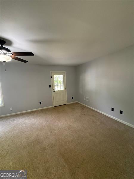 955 Tributary Way, Dacula, GA 30019 - carpeted spare room featuring a ceiling fan and baseboards