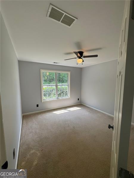 955 Tributary Way, Dacula, GA 30019 - empty room with carpet floors, baseboards, and ceiling fan