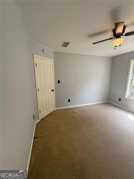 955 Tributary Way, Dacula, GA 30019 - carpeted spare room with baseboards and ceiling fan