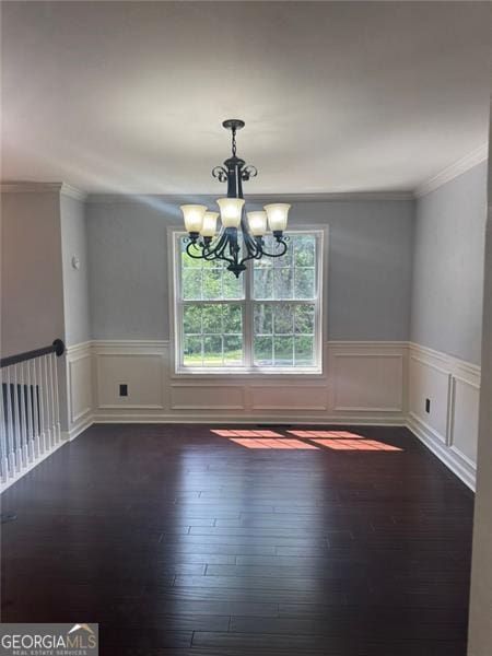 955 Tributary Way, Dacula, GA 30019 - unfurnished dining area featuring a chandelier, dark wood-type flooring, a wainscoted wall, crown molding, and a decorative wall