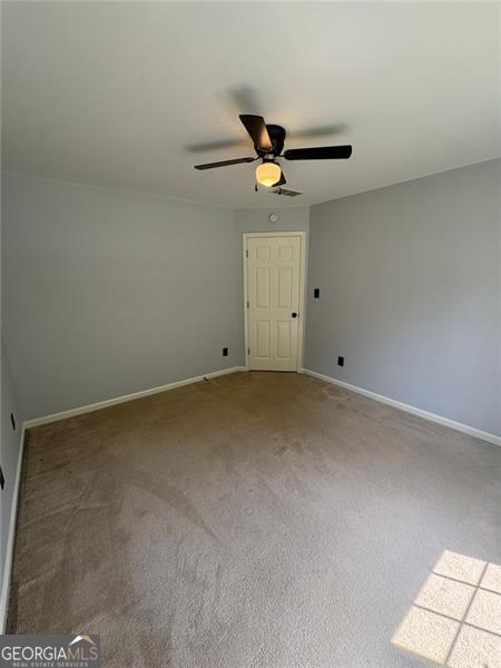 955 Tributary Way, Dacula, GA 30019 - empty room featuring ceiling fan and carpet floors