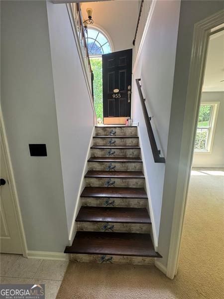 955 Tributary Way, Dacula, GA 30019 - stairs with plenty of natural light and carpet flooring