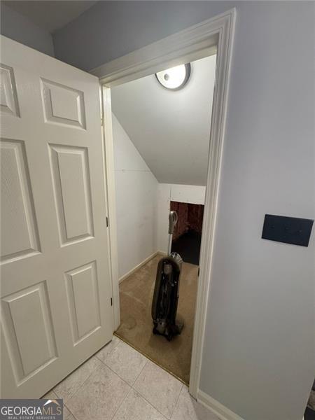 955 Tributary Way, Dacula, GA 30019 - hall featuring lofted ceiling, light carpet, light tile patterned floors, and baseboards