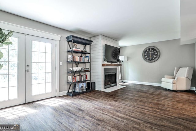 2302 Colonial Dr NE, Brookhaven, GA 30319 - living room with a fireplace with flush hearth, wood finished floors, french doors, and baseboards